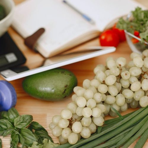 A vibrant composition of fruits, vegetables, and fitness items promoting a healthy lifestyle.